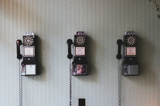 3 old pay telephones side by side 3-old-pay-telephones