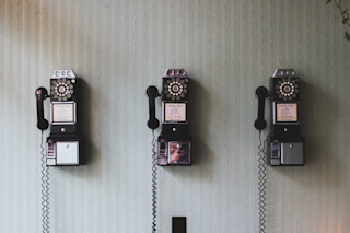 3 old pay telephones side by side 3-old-pay-telephones