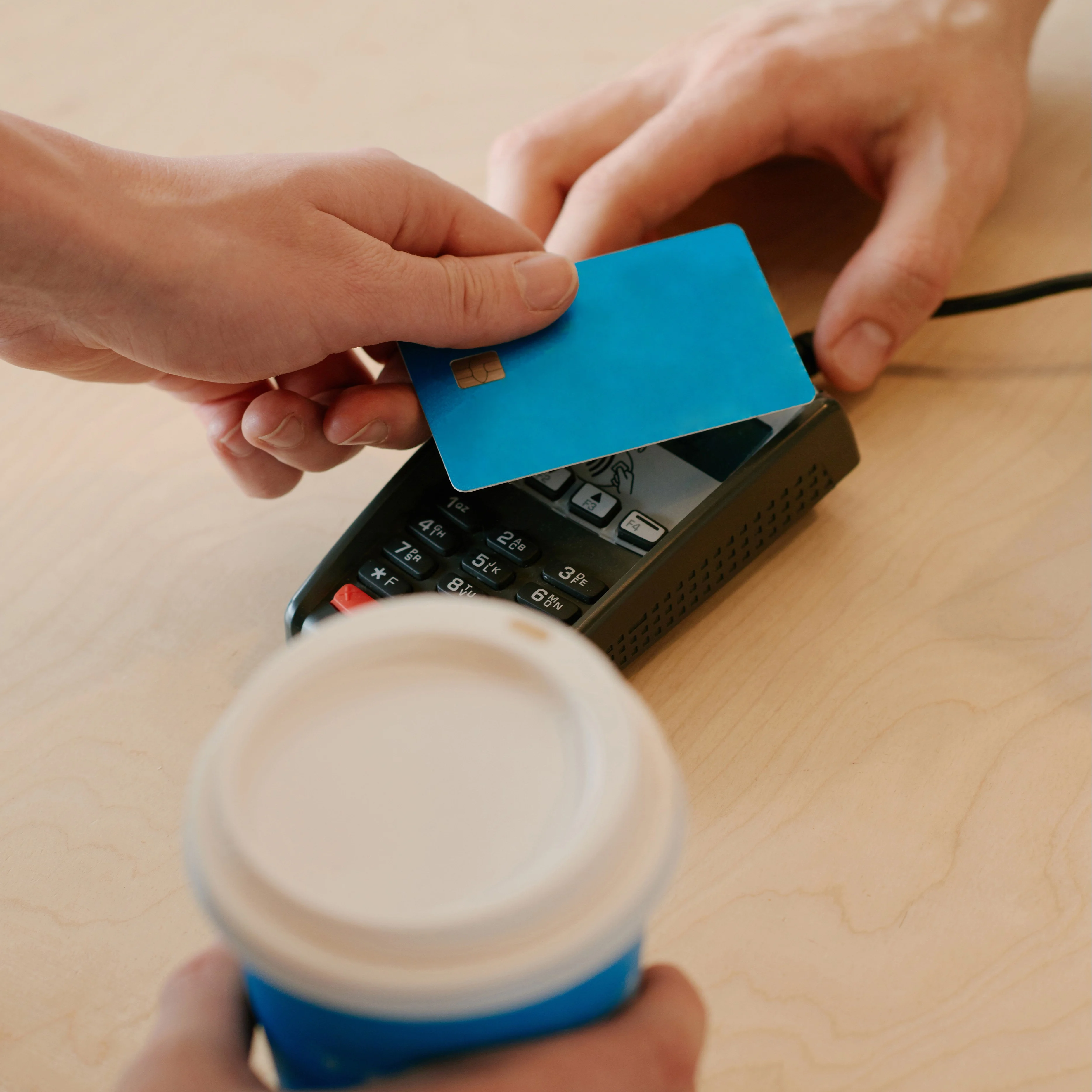 Two people interacting with a transaction tool and a credit card