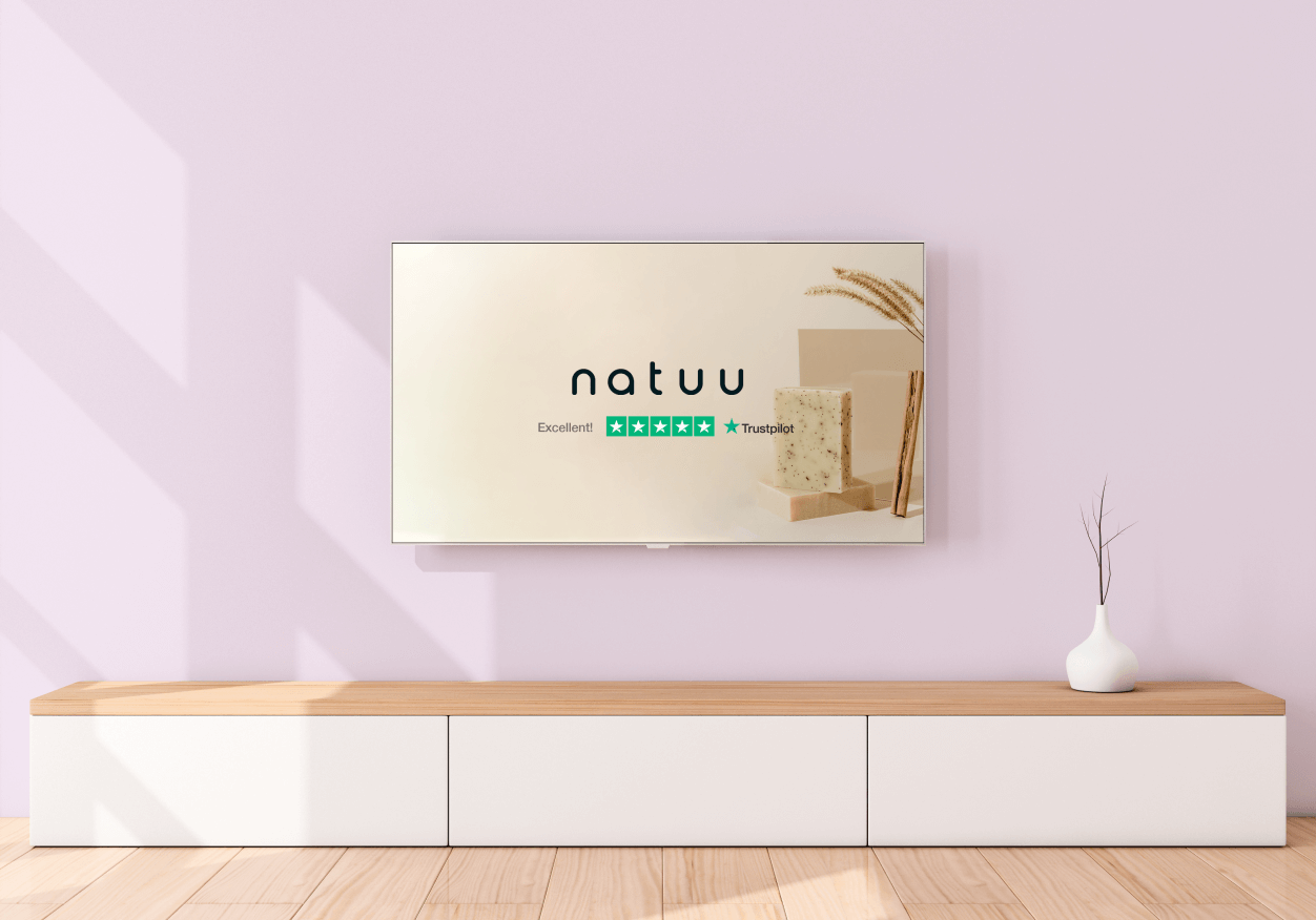Example photo of a TV in a living room showing a fake brand ad with Trustpilot's logo and rating Fake TV ad with Trustpilot rating