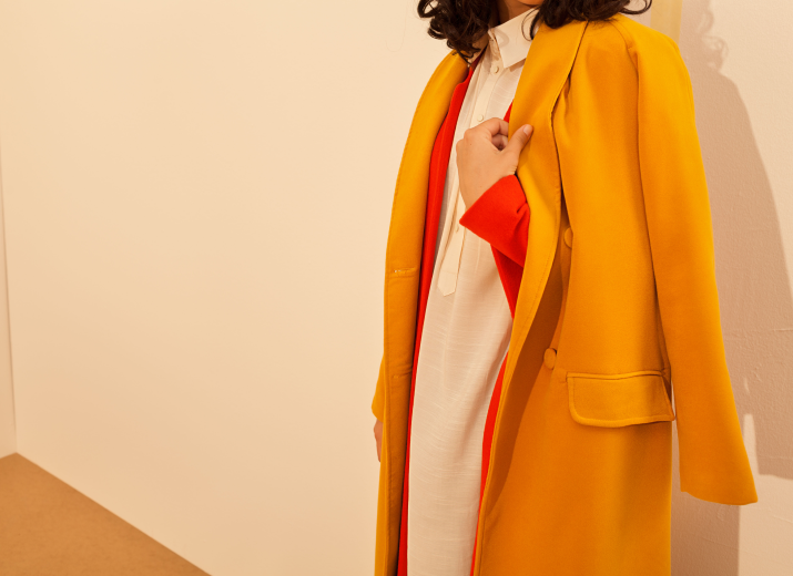 Young lady with long yellow coat Fashion industry - Drapers report image - How reviews are changing the fashion industry