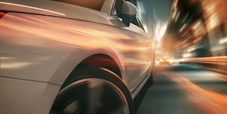 blurred car speeding by street lights fast car