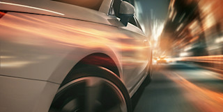 blurred car speeding by street lights fast car