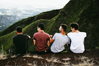Four men sitting on the each of a hill Social proof webinar