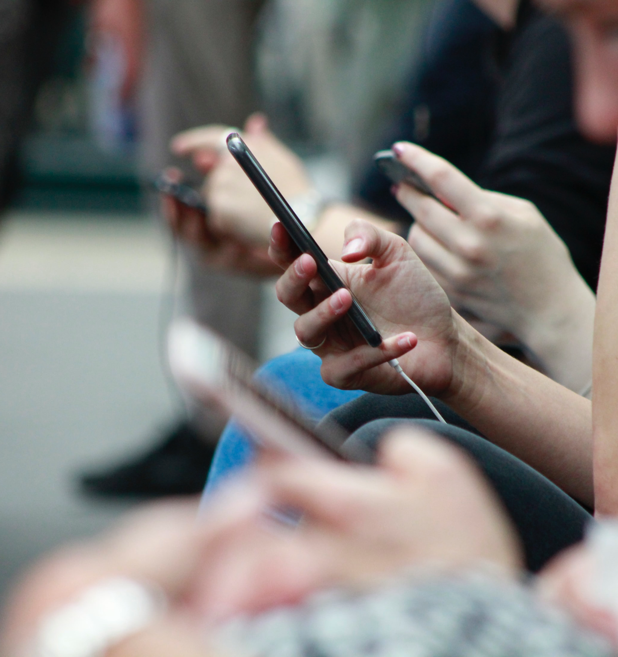Hands of several women holding smartphones Dashlane promo photo of hands holding smartphones