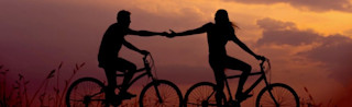 The power of trust - two people on bikes holding hands Making email marketing successful