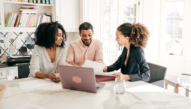 couple with paperwork and an adviser