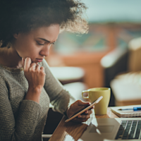 woman looking at her mobile phone thumbnail