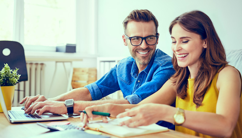 Couple smiling over paperwork