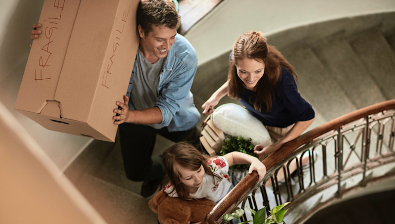 Family carrying things up a staircase