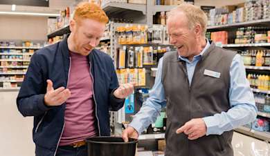 A Co-op member of staff with a customer.