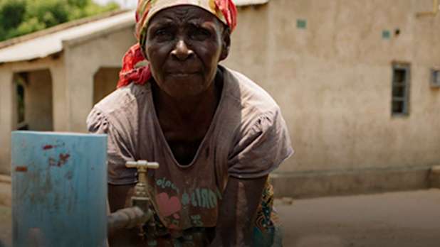 Ashanti Programme - A child fetching water at the standpipe