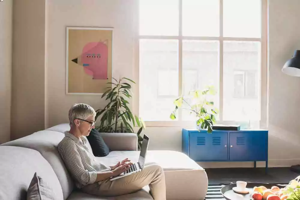 Photo of woman on computer on couch