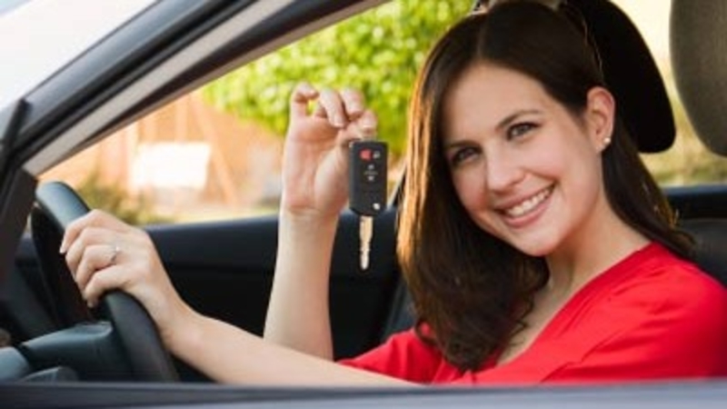 image of a lady holding a car key