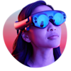 Young woman wearing Magic Leap One Creator Edition Lightwear lit by neon lights