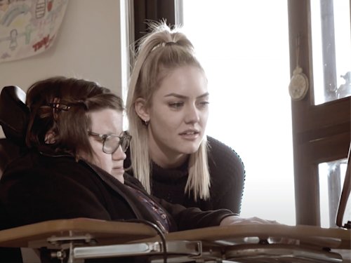 two people looking at a laptop screen