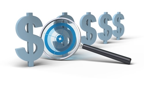 magnifying glass on dollars
