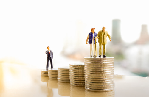Elderly Couple Figures on Pile of Coins
