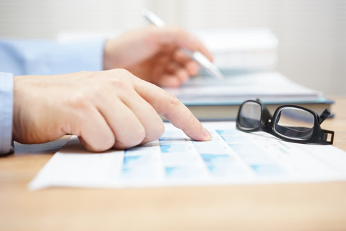 Man looking at Financial Papers