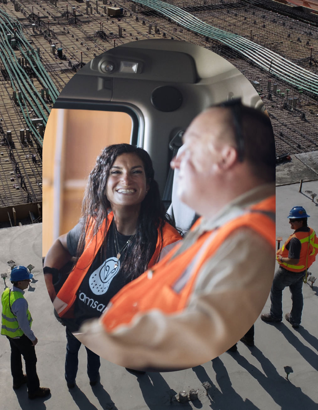 Two physical operations workers engaged in a lively conversation while sitting in truck.