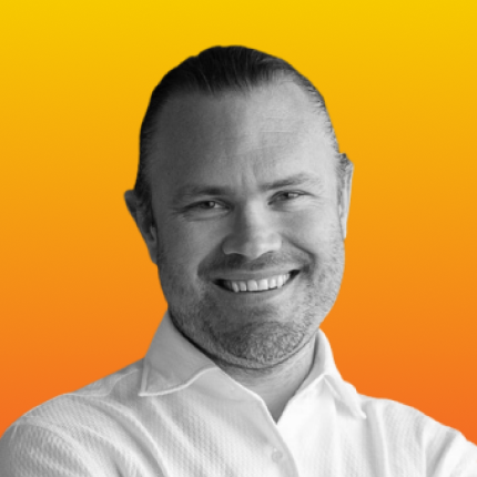 Johan Land shown in black and white, against a vibrant orange-yellow gradient background.