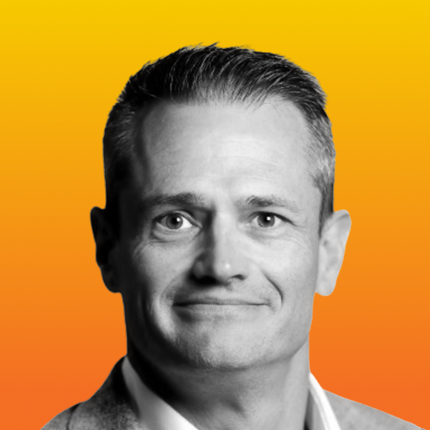Black and white headshot of Mike Keller against a vibrant orange-yellow gradient background.
