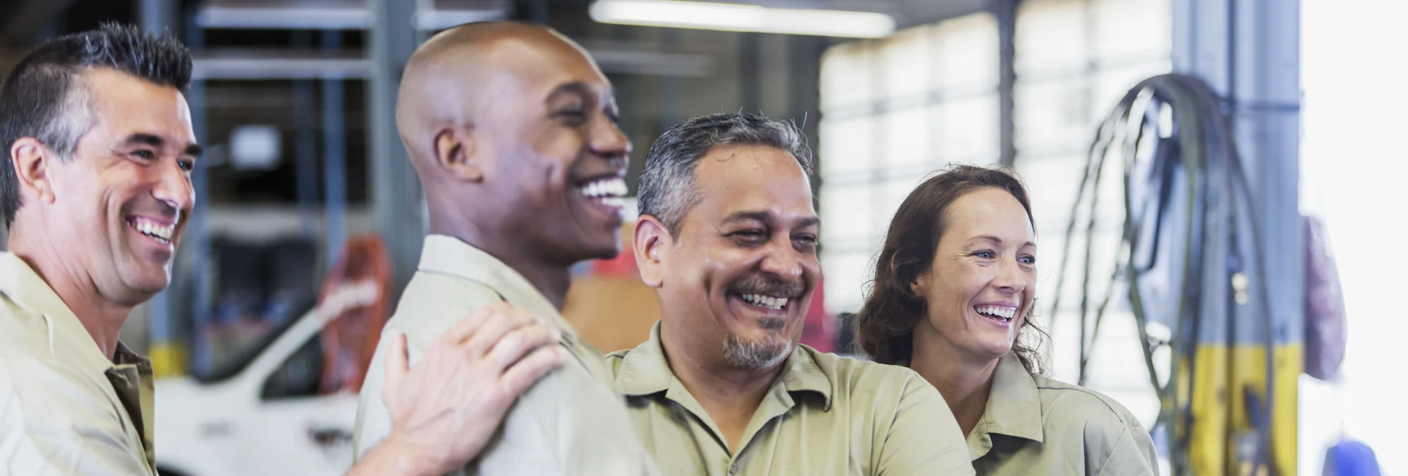 Happy truck drivers smiling in uniform