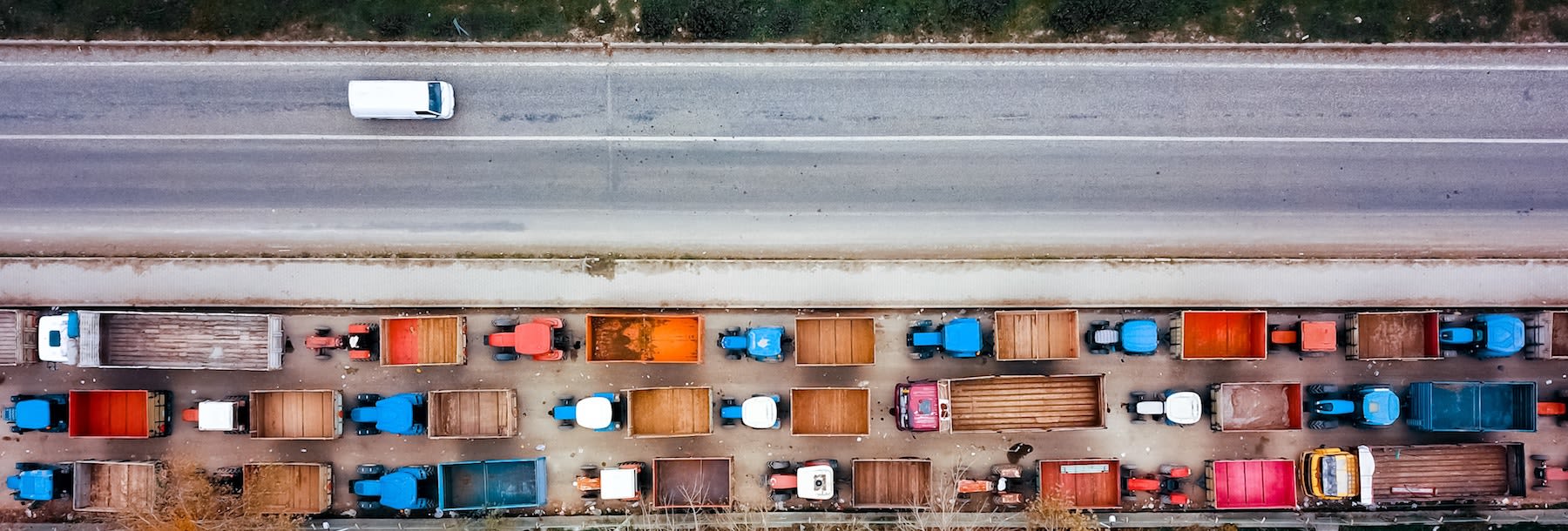 Trucks on a road in the fall.