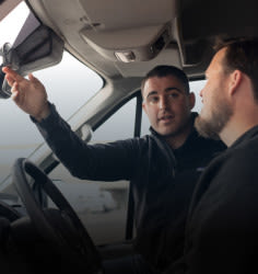 person pointing windshield