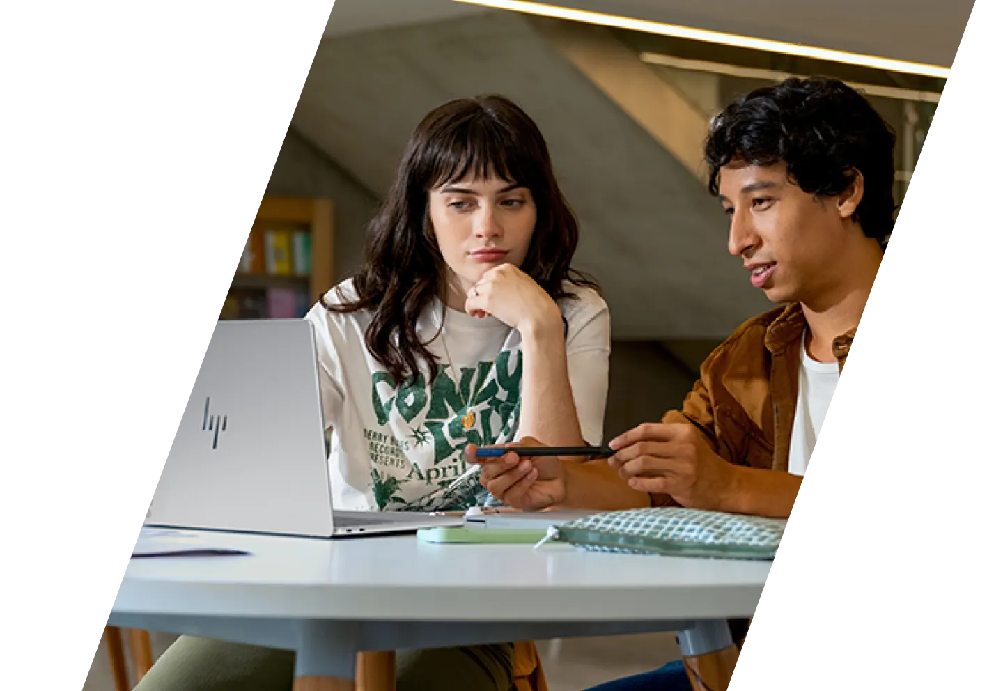 Image of two people looking at an HP laptop