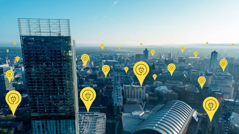 Electric charge point icons dotted across the Manchester skyline 