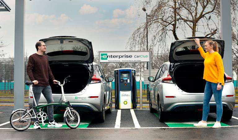Enterprise eCar Club man and woman with 2 cars and bike