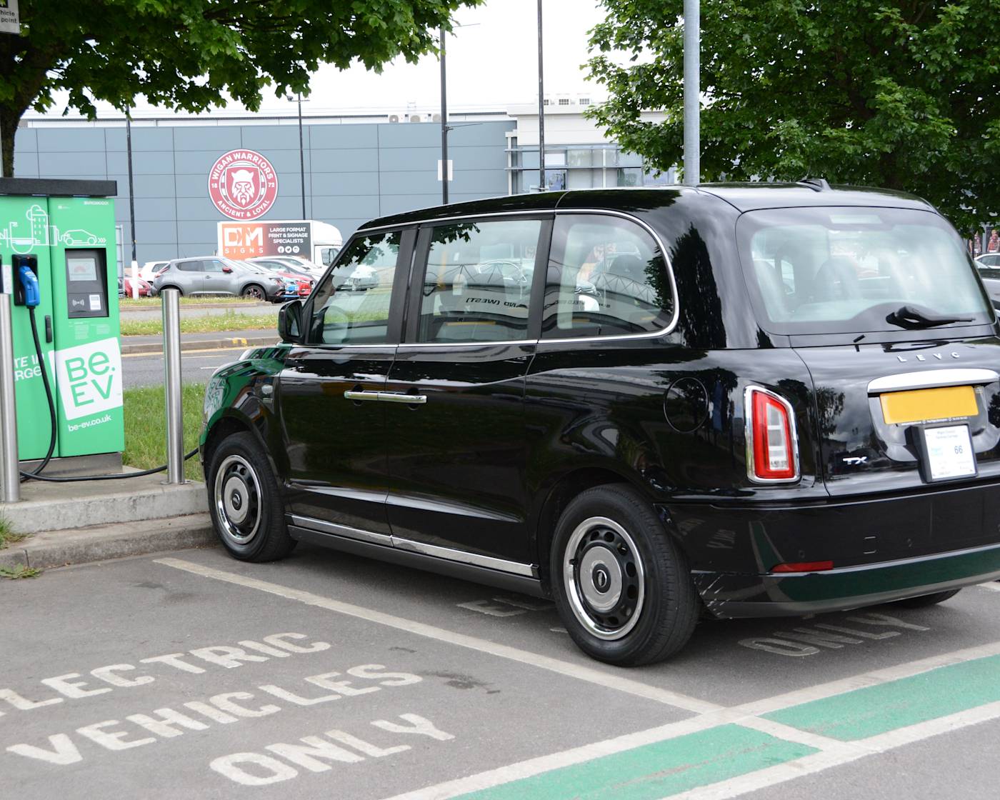 Black LEVC electric taxi at Be.EV charging point