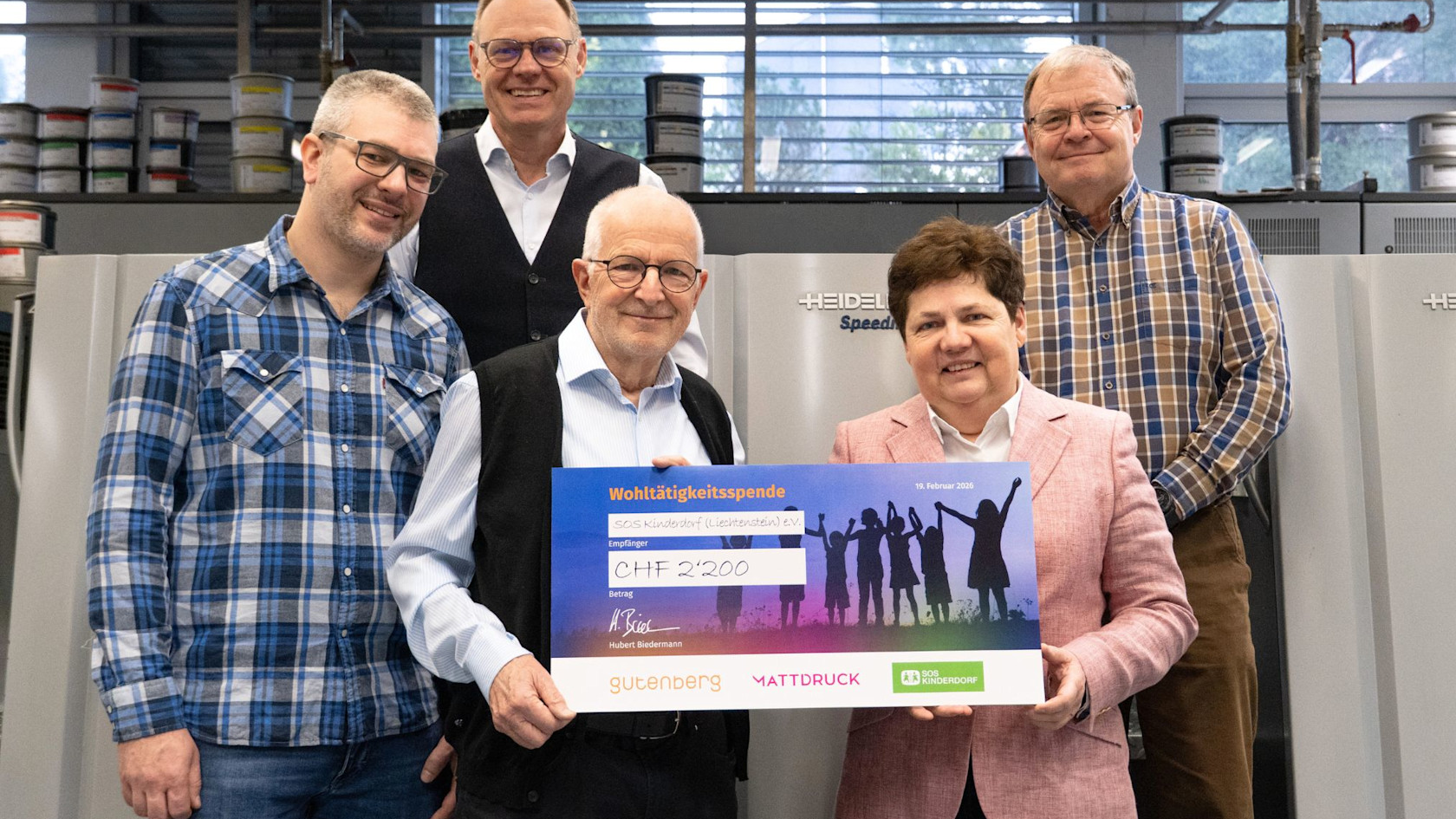Cheque presentation at Gutenberg AG printing company with Markus and Magdalena from SOS Children's Villages