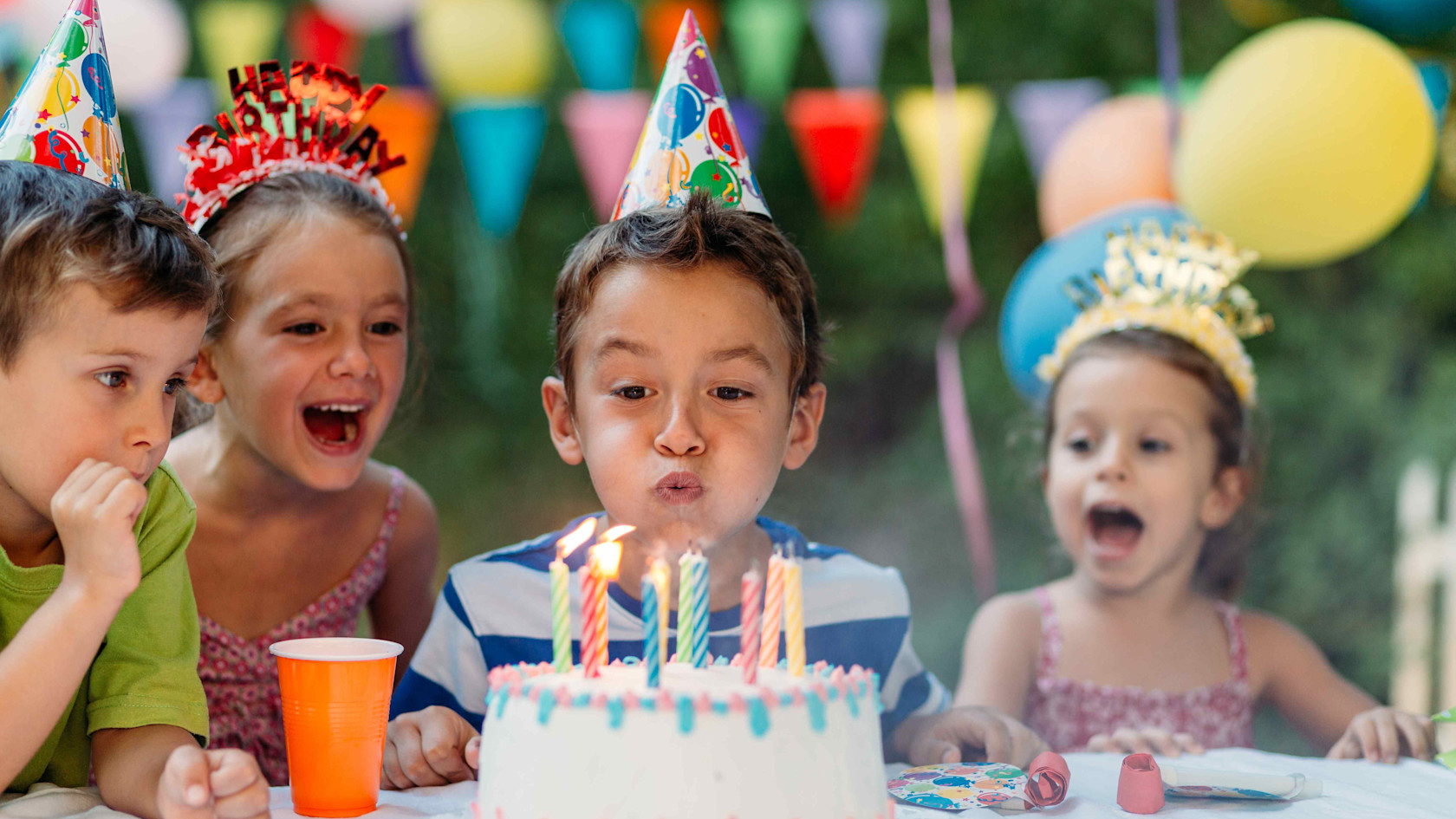 Children at the SOS Children's Village enjoy the birthday cake and blow out the candles.