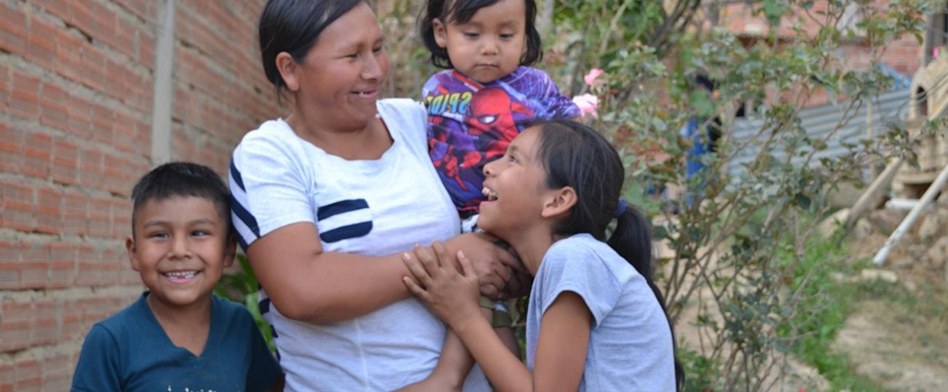 Mum with her three children - all laughing.