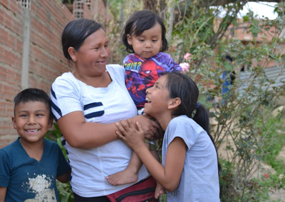 Mum with her three children - all laughing.