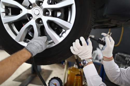 Professional mechanics checking a tire
