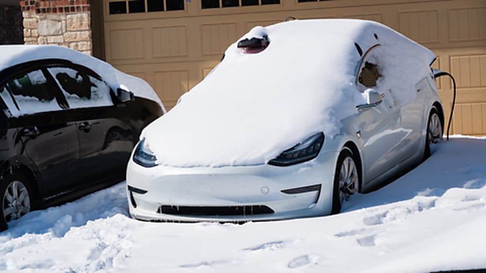 Charging an EV covered in snow