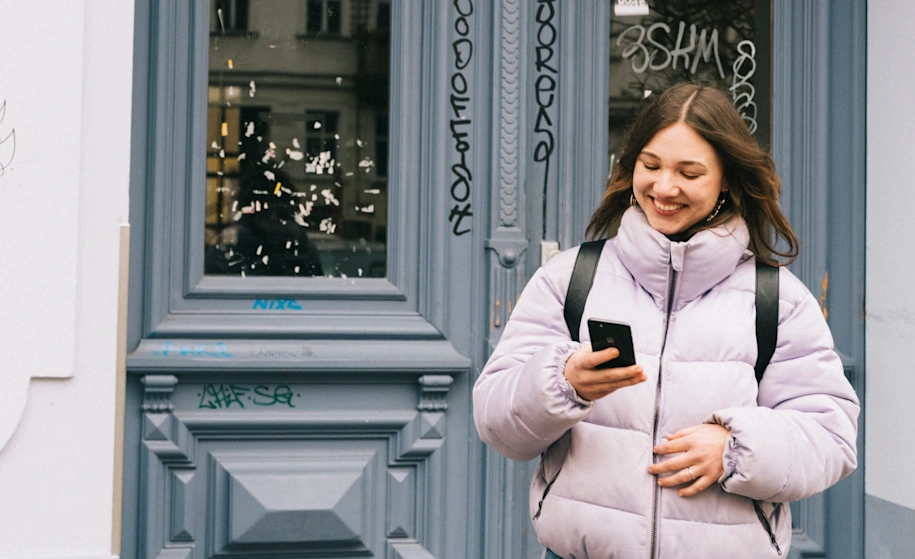 A woman using Pay by Bank on her mobile phone