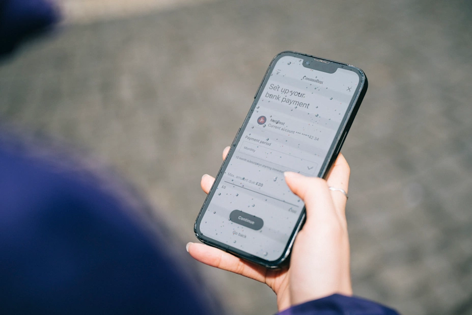 Person holding phone setting up bank