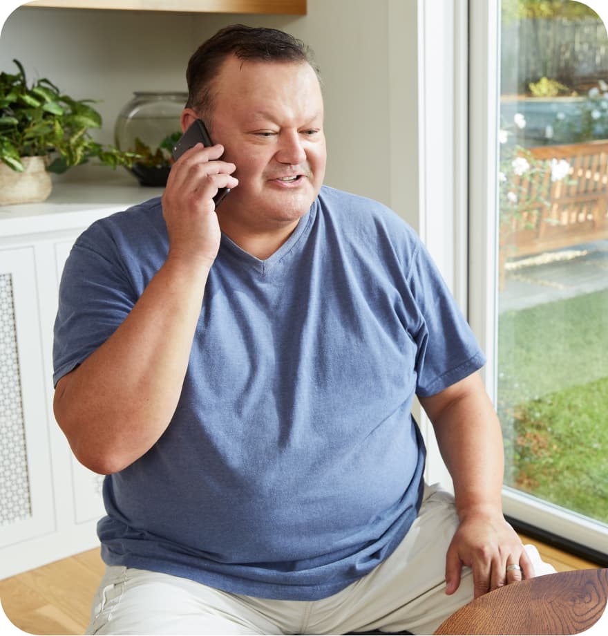 Person sitting while talking on the phone