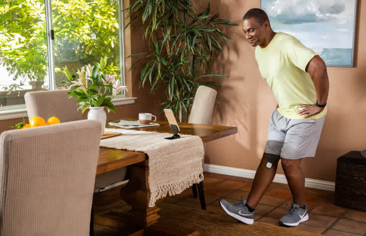 Man stretching with tablet and Enso on his leg
