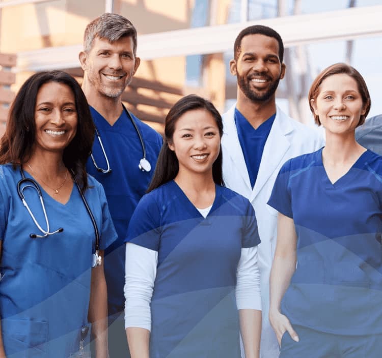 Doctors and nurses in front of building