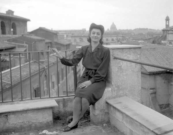 Woman Sitting on Balcony