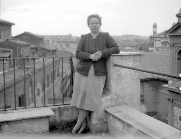 Woman Standing on Balcony