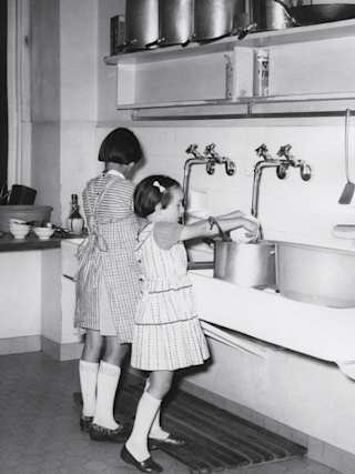 Kinder waschen Geschirr ab