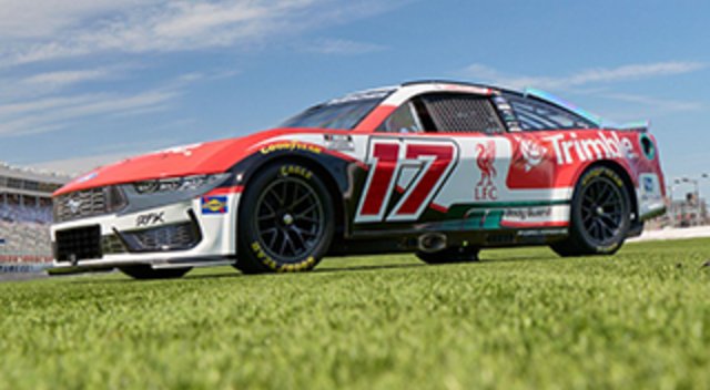 The No. 17 RFK Racing Ford Mustang featuring a special red, white, and green Liverpool FC and Trimble sponsorship livery on a grassy field.