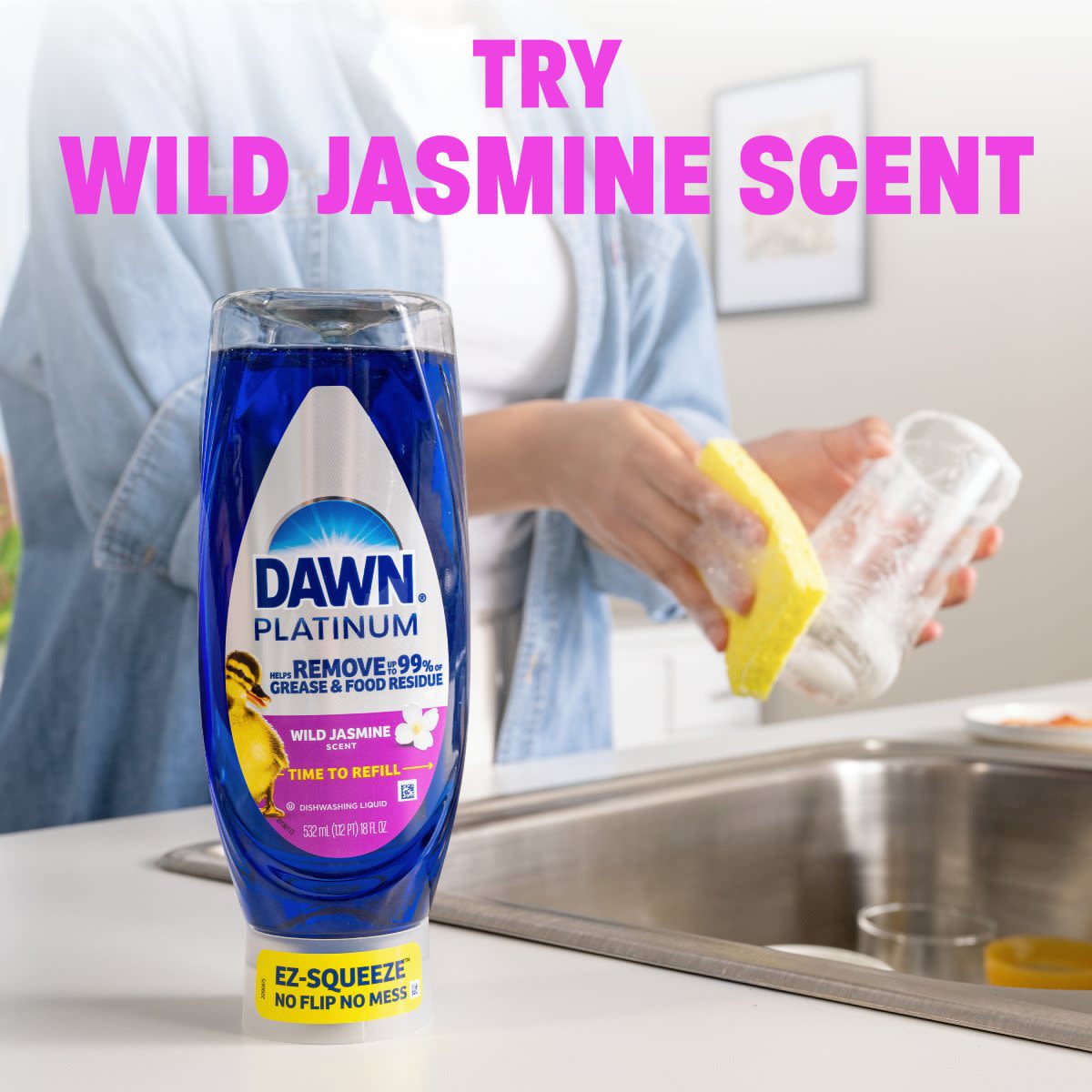 Dawn Platinum Wild Jasmine dish soap bottle with a person washing dishes in the background, highlighting grease removal benefits and scent