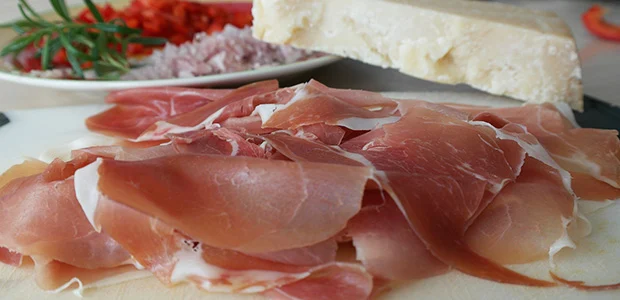 slices of parma ham beside cheese slices of parma ham beside cheese